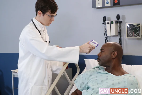 Two clothed adult men in a medical setting