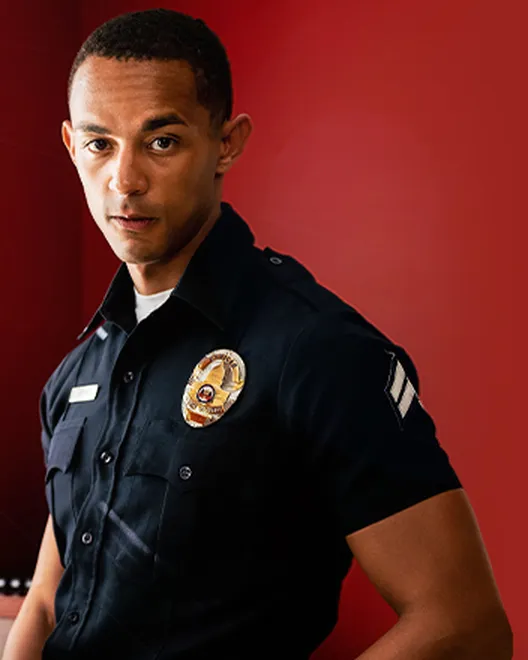 Promotional still from Icon Male: two men in police-uniform costumes
