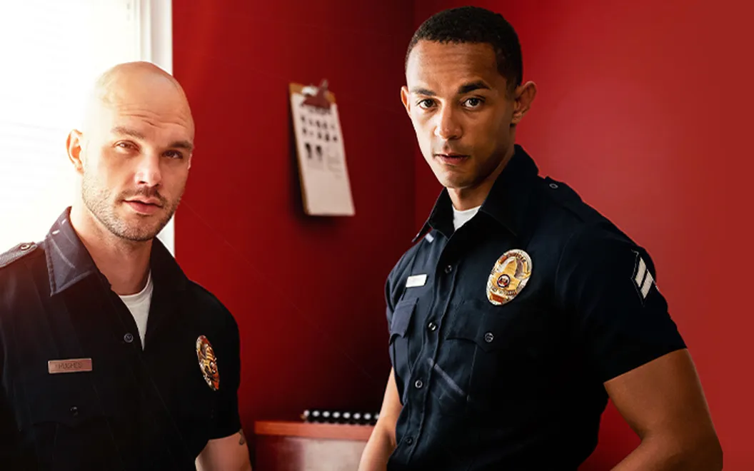 Promotional still from Icon Male: two men in police-uniform costumes