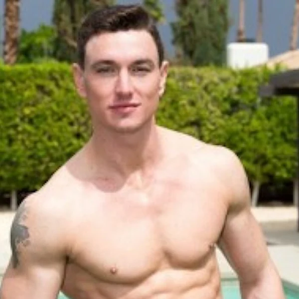 Adult model Cade Maddox beside a swimming pool, shirtless