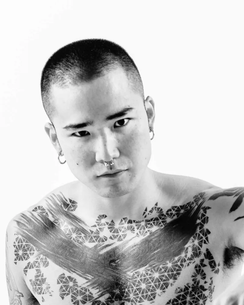 Black-and-white promotional portrait of Yoshi Kawasaki from Yoshi Kawasaki XXX