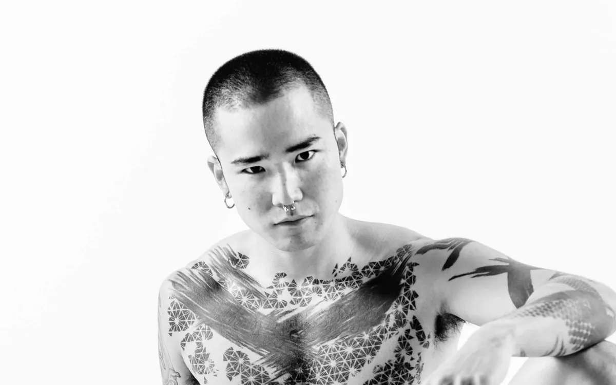 Black-and-white promotional portrait of Yoshi Kawasaki from Yoshi Kawasaki XXX
